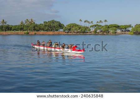 Honolulu, Dec. 29:  A fast-approaching women\'s outrigger canoe team practices for the State of Hawaii Outrigger Canoe Championships.  Honolulu, Hawaii USA.  Dec. 29, 2014.