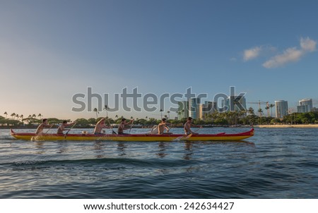 Honolulu, Jan 06:  An outrigger canoe team practices for the State of Hawaii Outrigger Canoe Championships as the sun sets on the stern of their canoe.  Honolulu, Hawaii, USA.  Jan. 06, 2015.