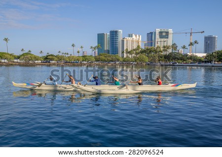Honolulu, Hawaii, USA, May 30, 2015: Women\'s outrigger canoe crew practices for the Summer Outrigger Canoe Regatta in Waikiki. Female canoe paddlers are a popular sport throughout the Pacific Islands.