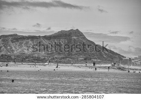 Honolulu, Hawaii, USA, June 8, 2015:  Diamond Head and Waikiki on an unusually windy day with passing showers and clouds in black, white, and gray tones.