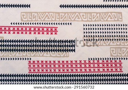 Samoan cloth fragment with red, black,and tan designs against a faded white background.