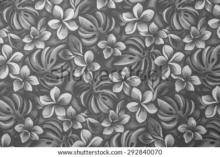 Vintage cloth fragment of Hawaiian plumeria leaves and flowers in tones of black, white, and grey.