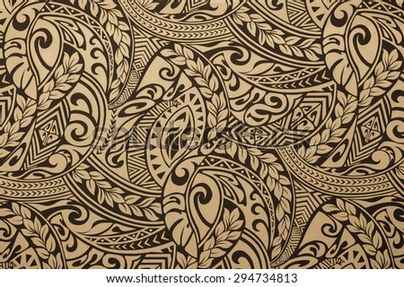 Hawaiian jungle  cloth design of black tattoo patterns on a faded yellow background.