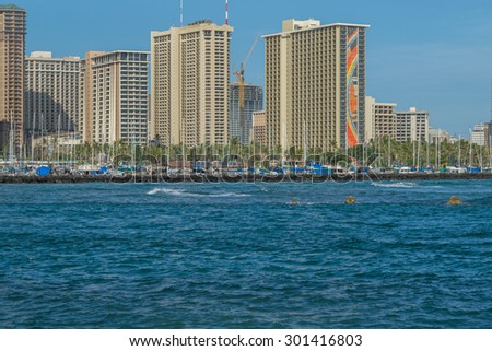 Honolulu, Hawaii, USA, July 30, 2015:  Late evening view of the Hilton Rainbow Tower and Waikiki resorts.  The refurbishment of the Rainbow Tower is now complete.