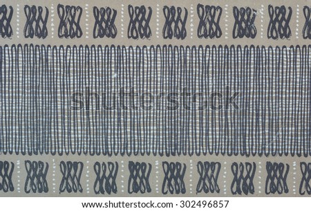 Vintage Hawaiian cloth fragment with black and gray pattern on a tan and white background.