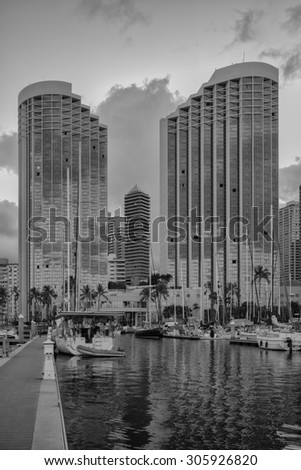 Honolulu, Hawaii, USA, August 14, 2015:  Dawn view of the Ala Wai Harbor with the twin towers of the Hawaii Prince Hotel in the background.  The Hawaii Prince hotel is Waikiki\'s newest hotel.