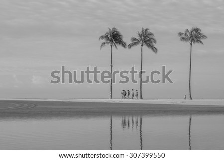 Honolulu, Hawaii, USA, August 18, 2015: Morning view of a group of people walking at the Honolulu Lagoon on a calm day. Honolulu Lagoon has been refurbished and is open for recreational activities.