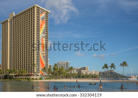 Honolulu, Hawaii, USA, Oct. 27, 2015: Afternoon view of the Hilton Rainbow Tower with guests enjoying Waikiki Lagoon with resorts and Diamond Head in the background. Waikiki is a favorite destination.