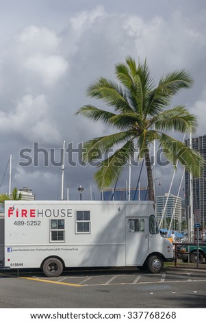 Honolulu, Hawaii, USA, Nov. 10, 2015:  Tropical plate lunch truck parked under a shady coconut palm tree in Waikiki.  Plate lunch trucks are popular in Honolulu.
