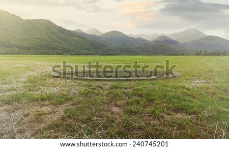 Beautiful simple landscape with a hole in ground and mountains