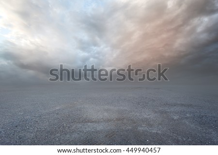 Fantasy gravel background with dramatic sky and grass