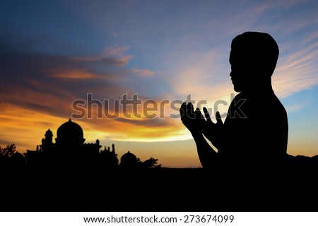 Silhouette muslim people  praying at sunset.