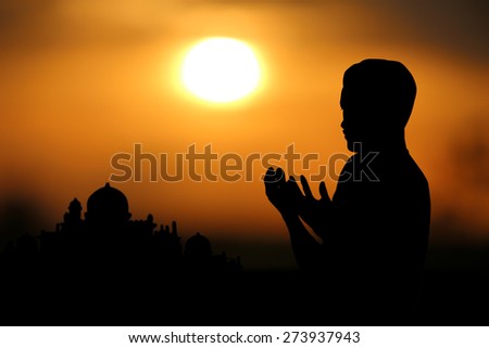Silhouette muslim people  praying at sunset.