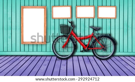 red bicycle on color wooden house wall.
