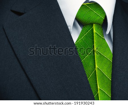 Business suit and green leaves as tie representing a natural job in defense of a green environment.