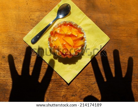 Hands reaching for dessert. The concept of craving for sweet snacks.