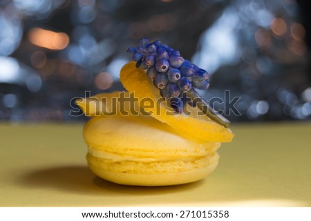 Gourmet small colorful French macarons with lemon flavor, colorful bokeh and violet.