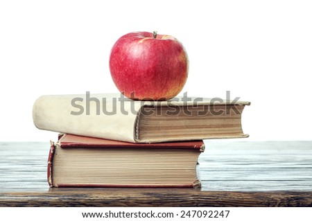 Apple and books on the table with isolated background