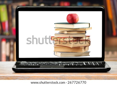 Books and apple on laptop screen