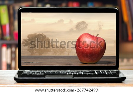 Red apple on laptop screen