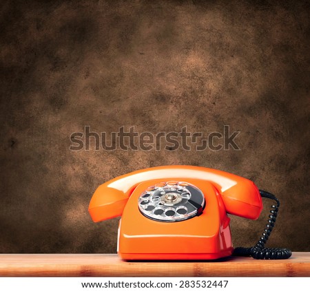 Vintage phone on a brown grunge background