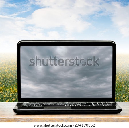 Sunny weather in the real world and the clouds on a laptop