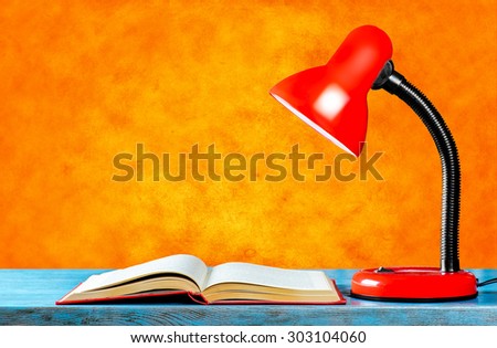The book and the lamp on the table