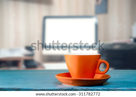 Orange cup on office desk