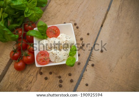 Mozzarella cheese in a bowl on a wooden table