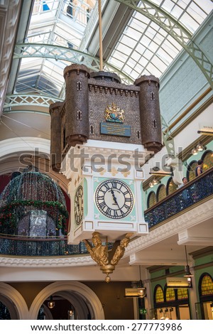 SYDNEY, AUSTRALIA - Dec 26: A hanging clock inside the Queen Victoria Building shows time on Dec 26, 20114 in Sydney. The QVB is a high-end shopping precinct in Sydney and a famous tourist attraction.