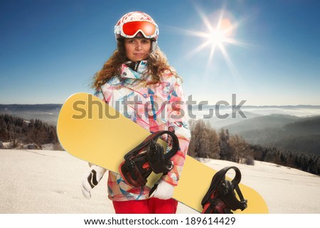 Portrait of young woman with snowboard