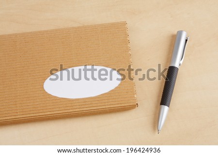 Paper box with pen on the wooden desk