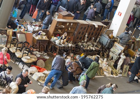 Barcelona, Spain - March 12, 2014: The most famous flea market in Barcelona, also known as Els Encants Vells.Customers choosing and looking for something interesting while the vendor expected.