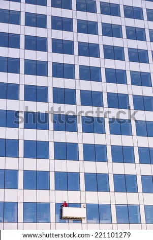 window cleaner cleaning the facade of an office skyscraper in Barcelona