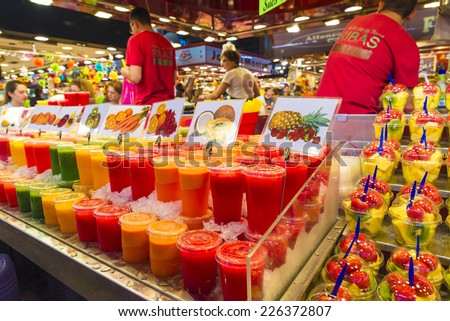 Barcelona, Spain - October 17, 2014: Fruit stand with chopped fruit and smoothies ready to take on the market of La Boqueria