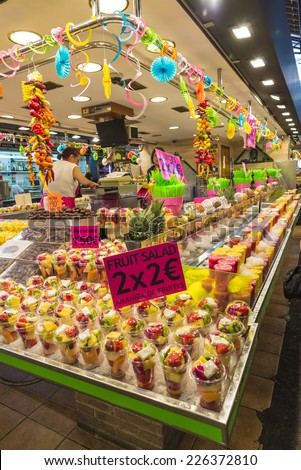 Barcelona, Spain - October 17, 2014: Fruit stand with chopped fruit and smoothies ready to take on the market of La Boqueria