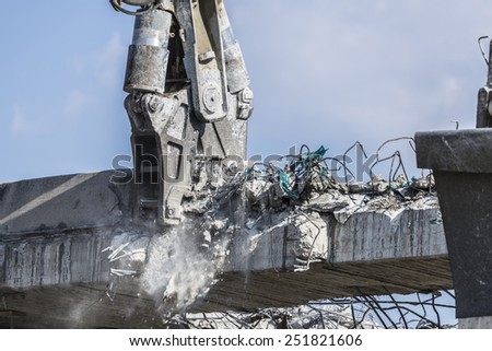 A crane breaking down a building
