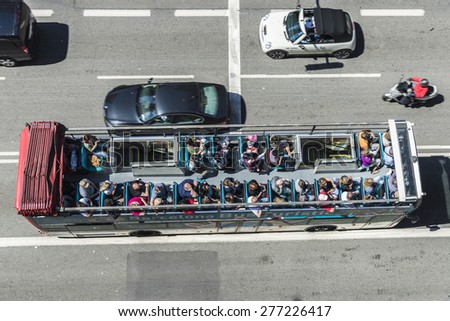 Barcelona, Spain - May 2, 2015: Aerial view of a tourist bus in motion. Barcelona City Tour is an official touristic bus service that shows the city with an audio guide.