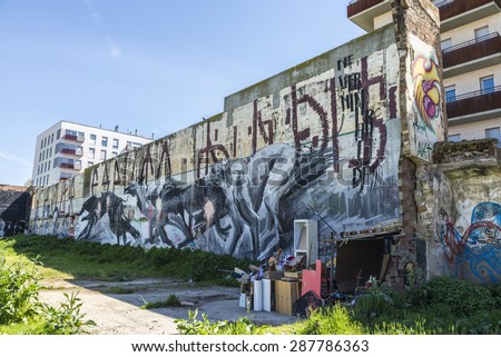 Barcelona, Spain - April 9, 2015: Wall covered with graffiti of dogs running beside a barrack