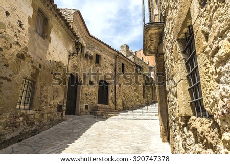 Medieval street with a tower defense in Pals, Girona, Catalonia, Spain