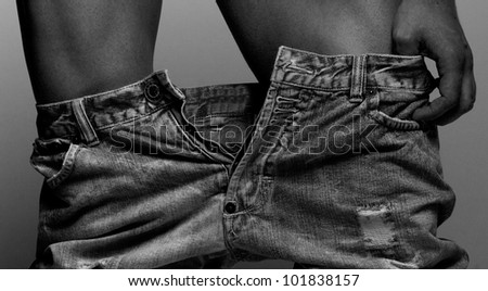 Artistic photo of man`s jeans pants down