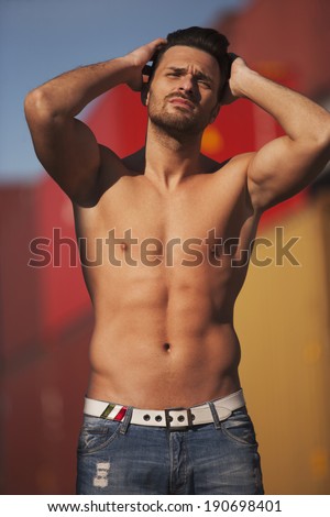 Man in jeans posing, muscular body, low body fat, fitness