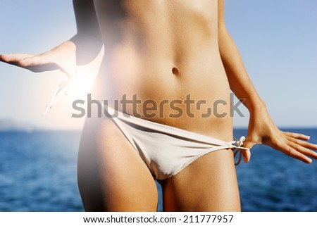 Wonderful female dark tanned body in summer