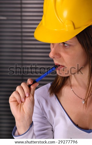 Young woman - engineer wearing a hard hat