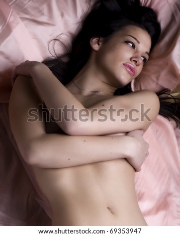 stock photo Fashion photo of a woman nude on satin bed