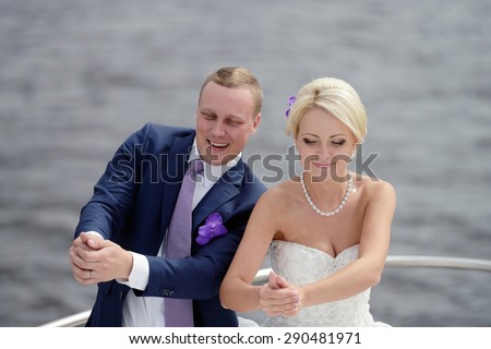 Wedding couple on the nature is dancing. Beautiful model girl in white dress. Handsome man in suit. Beauty bride with groom. Female and male portrait. Woman with lace veil. Lady and guy outdoors