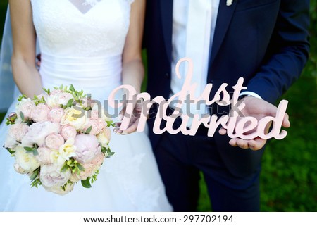 Wedding couple with bouquet. Female and male portrait. Beautiful model girl in white dress. Man in suit. Beauty bride wiÂ¬th groom. Woman in bridal gown. Cute lady and guy outdoors