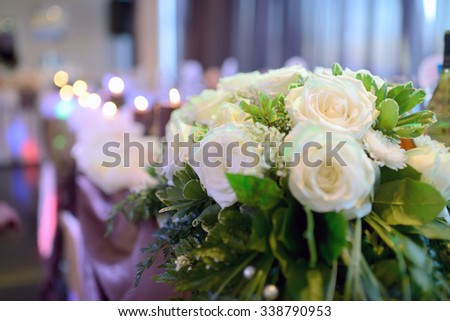 Beautiful wedding restaurant for marriage. White decor for bride and groom. Colorful decoration for celebration. Beauty bridal interior. Bouquet, food and flowers in hall