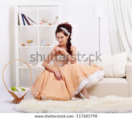 portrait of young beautiful retro woman in skirt with petticoat and corset posing in vintage interior