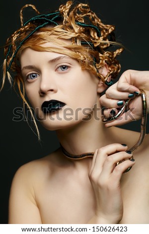 portrait of beautiful young woman with creative hairdo tearing away collar from her neck